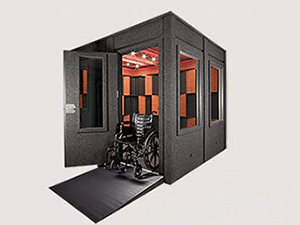 An 8'x8' WhisperRoom sound isolation booth with a wheelchair ramp and ADA package
