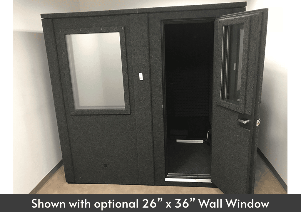 A WhisperRoom 6084 E double-wall isolation booth shown inside of an empty room with the door open.