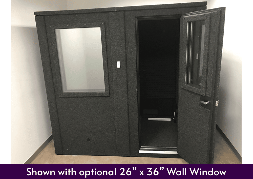 A WhisperRoom 6084 E double-wall isolation booth shown inside of an empty room with the door open.