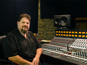 Steve Chadie sitting next to his mixing console