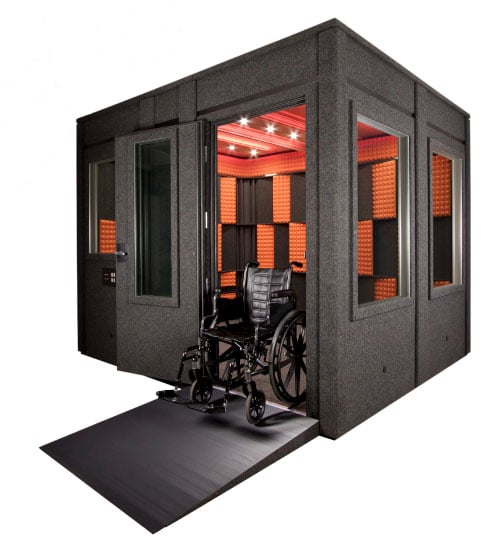 A whisperroom soundproof booth shown with the ADA package and wheelchair on wheelchair ramp