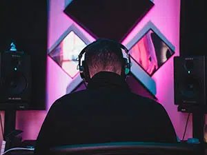 A music producer sitting at his workstation