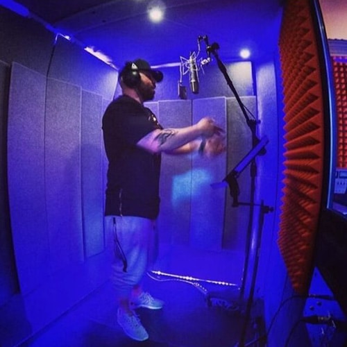 A man performing vocals inside of a WhisperRoom vocal booth