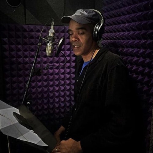 A man recording a narration inside of his WhisperRoom vocal booth