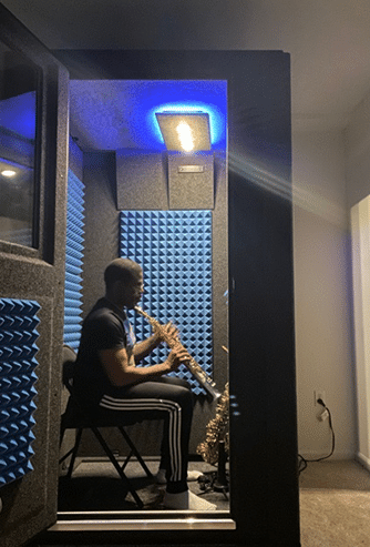 Musician Antonio Hart practicing inside of his WhisperRoom rehearsal booth.