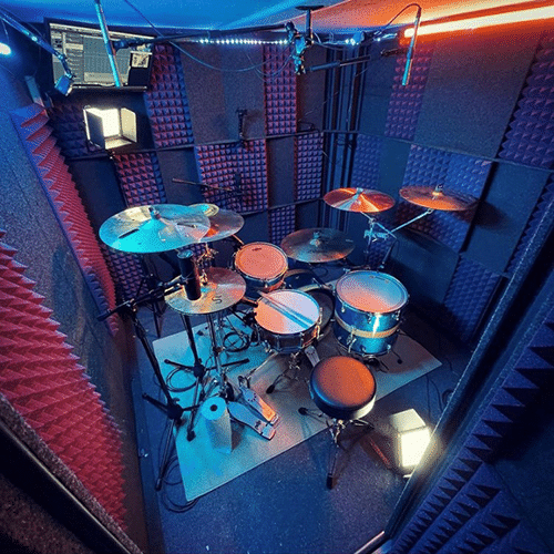 A full drum set inside of a WhisperRoom drum booth.