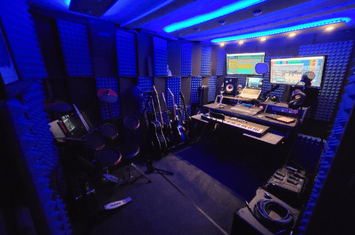 Matt Goodwin's WhisperRoom filled with recording gear, guitars, a producer's desk, and more equipment.