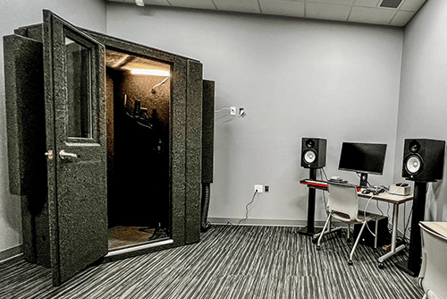 A WhisperRoom MDL 127 LP S shown in the corner of a high school's music lab.