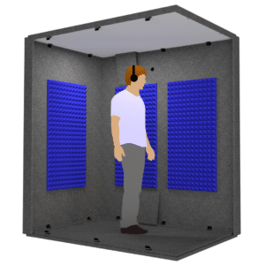 A man standing with headphones on inside the Audiology Basic Package illustrates the interior size of the unit.