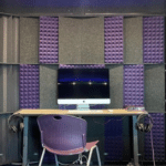 Interior image of a WhisperRoom recording booth with purple acoustic foam.