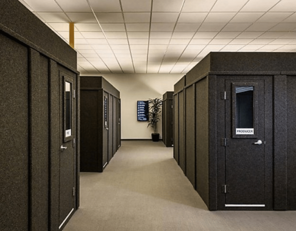 Several WhisperRoom privacy booths arranged in a large open floor office. These spacious privacy booths serve as individual offices for employees, providing a secluded and focused work environment within the bustling office space.