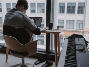 Man in Recording Studio with Headphones and Laptop - Exploring Music Promotion Through Digital Content
