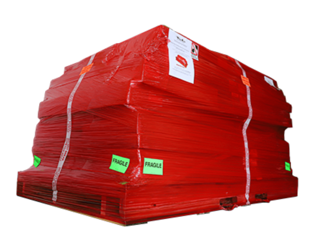 Image displaying a WhisperRoom prepared for shipment: A pallet wrapped in red shrink-wrap containing individual boxed components ready for delivery.