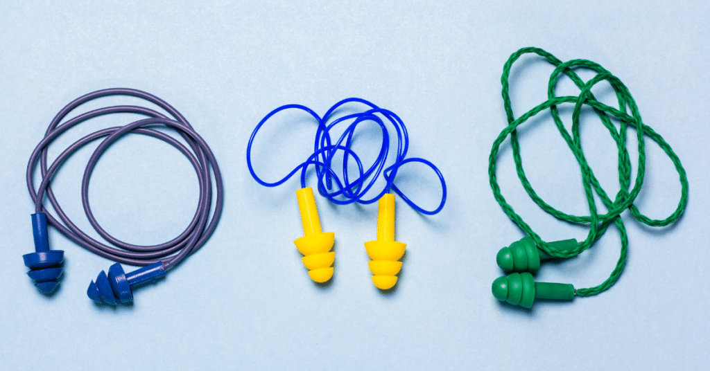 An image of 3 earplug sets with a light blue background to illustrate the importance of wearing ear protection in loud environments.