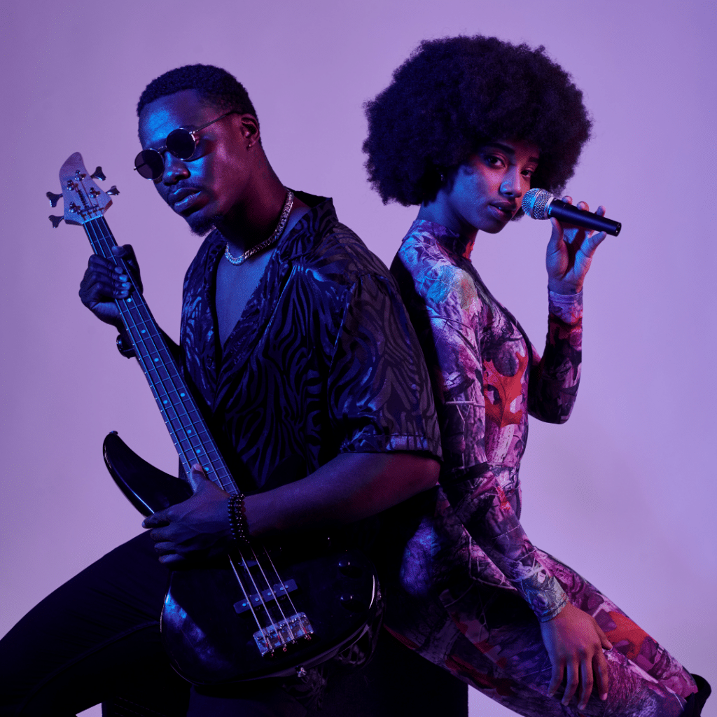 Male bass player and female vocalist of a musical group posing for a press photo with a cool vibe aesthetic, illuminated by purple lights, highlighting their personal brand image.