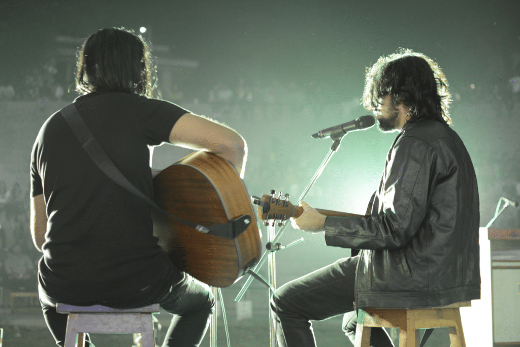 Two musicians performing at a small live venue.